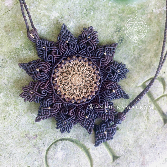 Handcrafted boho necklace with detailed macrame and brass filigree charm.