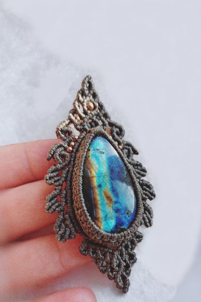 This Spectrolite Labradorite Macrame Necklace is a stunning statement piece that features a 57ct teardrop-shaped gemstone with full flash and AAA quality.