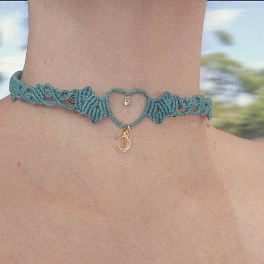Boho macrame choker features a lovely crescent moon charm plated with 18K gold. This necklace is the perfect statement piece for any hippie-style outfit. This versatile piece can be worn as a crew neck necklace or even as a tiara.