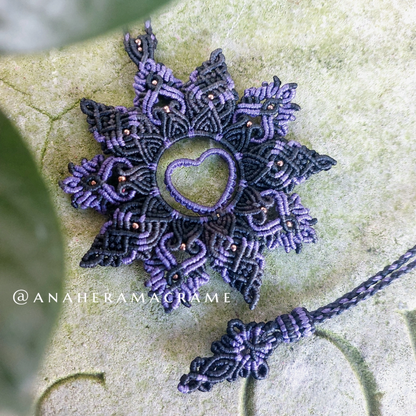 Bohemian-style purple and black macrame necklace with heart design.  

