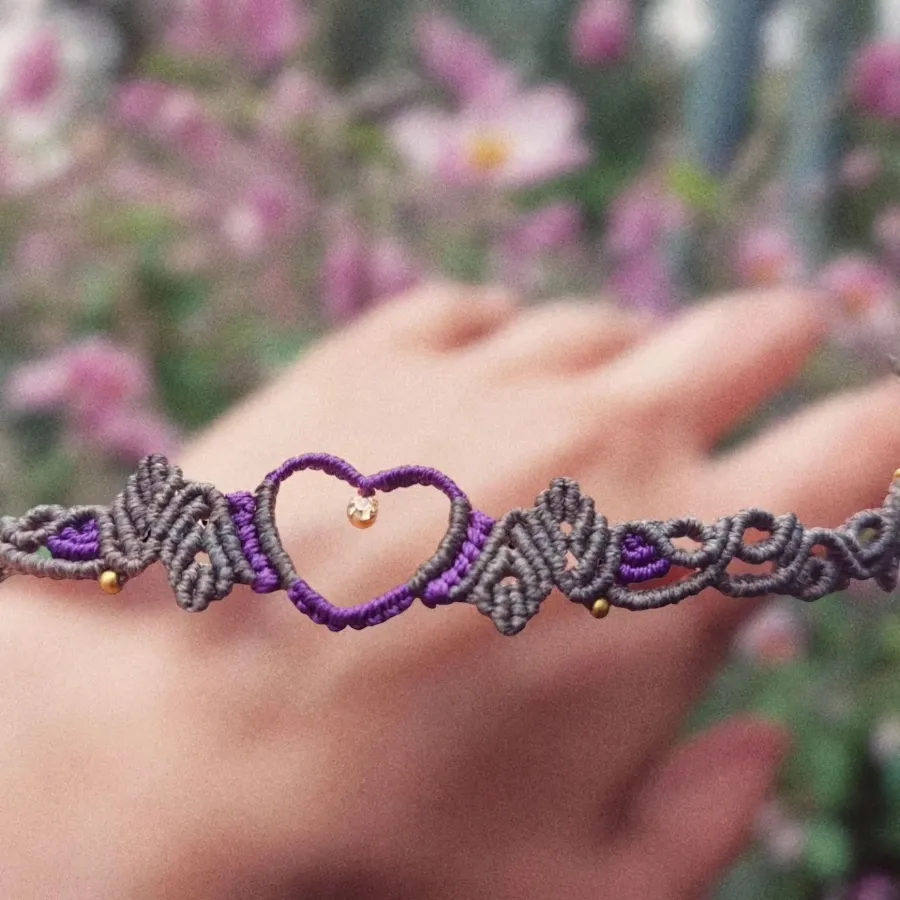 purple choker rhinestone pendant encased within a heart-shaped brass setting