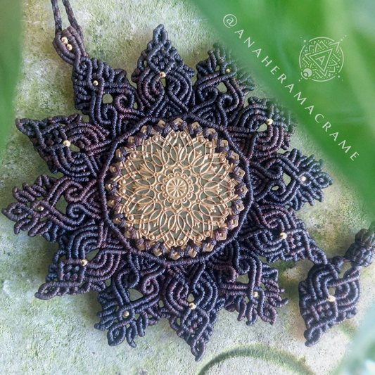 Mandala macrame necklace with an intricate brass filigree centerpiece.  
