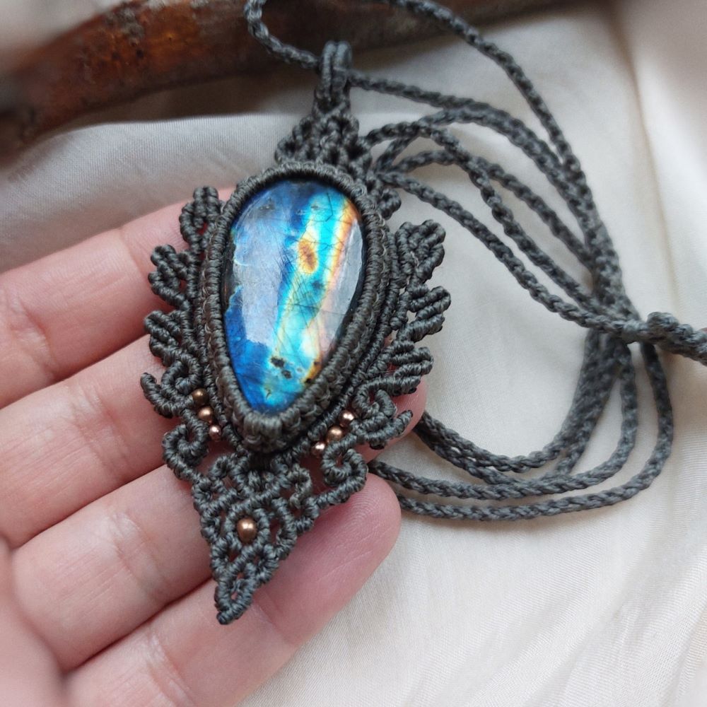 This Spectrolite Labradorite Macrame Necklace is a stunning statement piece that features a 57ct teardrop-shaped gemstone with full flash and AAA quality. 