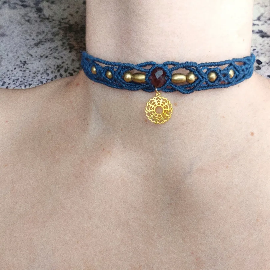 The Boho macrame choker features The Crown Chakra charm that's plated with 18K gold. The Crown Chakra, also known as Sahasrara, is positioned at the topmost part of the head and is the last of the seven chakras. This versatile piece can be worn as a crew neck necklace or even as a tiara.