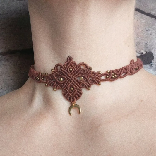 boho macrame choker featuring a lovely crescent moon charm that's plated with 18K gold, this necklace is the perfect statement piece for any hippie-style outfit. This versatile piece can be worn as a crew neck necklace or even as a tiara.