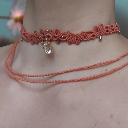 Lightweight handmade macrame choker with golden accents and a Cubic Zirconia heart charm, designed for adjustable comfort.
