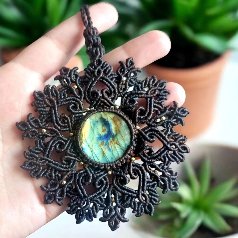 Labradorite pendant with iridescent colors on a handcrafted macrame necklace.