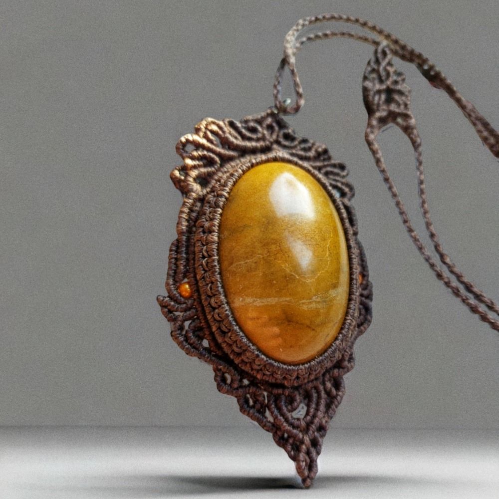 The Limonite cabochon, with its yellow/orange hue, serves as the centerpiece of this unique macrame necklace. The cabochon is paired with the same color beads to create a one-of-a-kind piece of jewelry. With an adjustable length of approximately 54cm/21.2 inches, this necklace can be easily adjusted to fit any neck with a convenient slide lock feature.  limonite cabochon size: 5cm/3cm