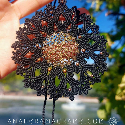 Black macrame necklace with intricate mandala design and brass filigree centerpiece.