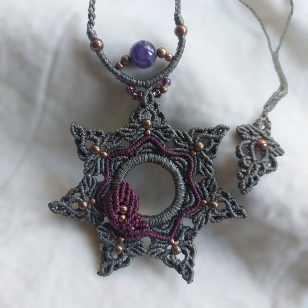 The macrame mandala necklace features a purple leaf design and an amethyst bead. The necklace has an adjustable length of approximately 51cm/20 inches, including the pendant