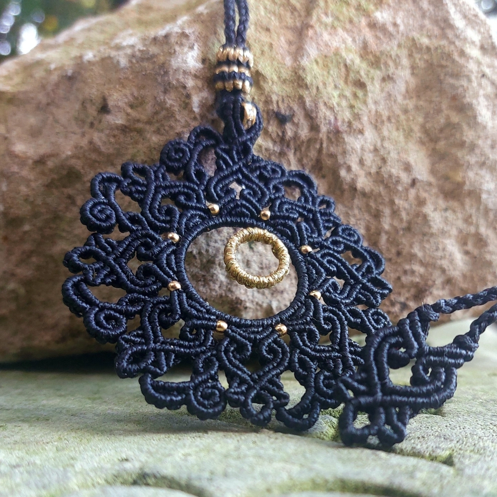 Bohemian macrame mandala necklace with golden bead details and rondelle bead on top, great for bold and artistic fashion styles.
