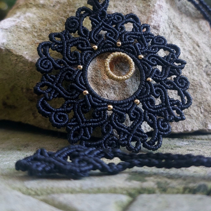 Unique black mandala necklace with a golden rondelle bead and artisan craftsmanship, perfect for gifting or personal wear.
