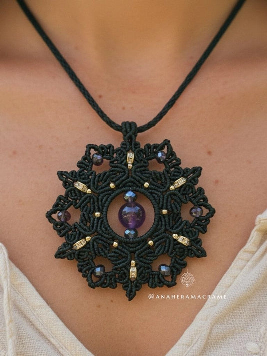 Black lace pendant necklace with purple gemstone on a person's neck