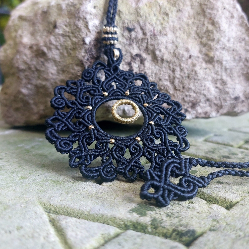 Lightweight black macrame necklace with golden accents and a rondelle bead, perfect for casual and formal boho outfits.
